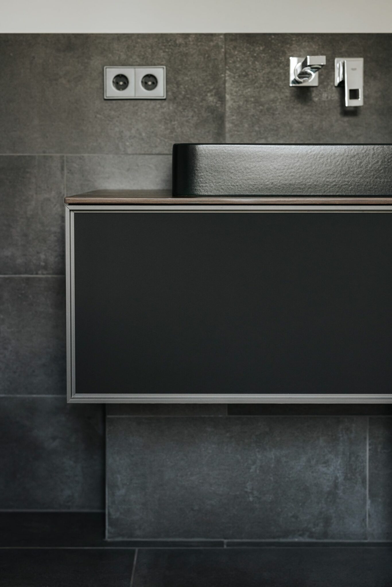 High-end material composition featuring rare stone vanities and sophisticated wall treatments.