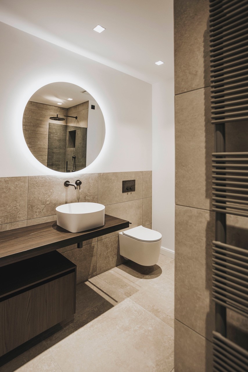 High-end material composition featuring rare stone vanities and sophisticated wall treatments.